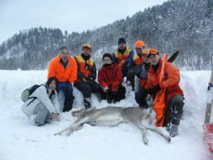 捕獲したシカの前で集合写真